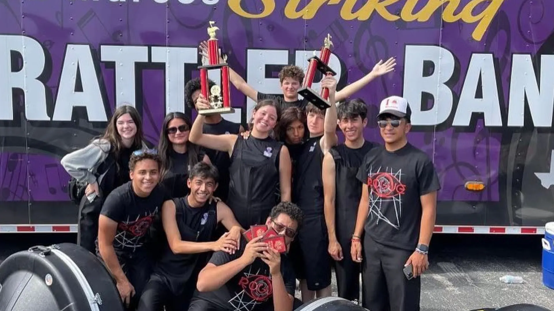 San Marcos High School Rattler Band members holding trophies